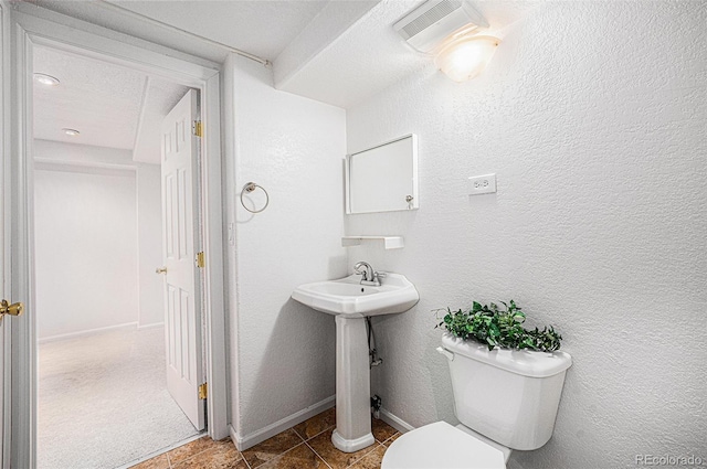 5607 S Gray St, Littleton, CO 80123 - bathroom featuring a textured wall, a sink, toilet, baseboards, and visible vents