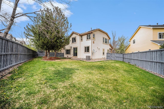 5607 S Gray St, Littleton, CO 80123 - rear view of house featuring a fenced backyard, stucco siding, and a yard