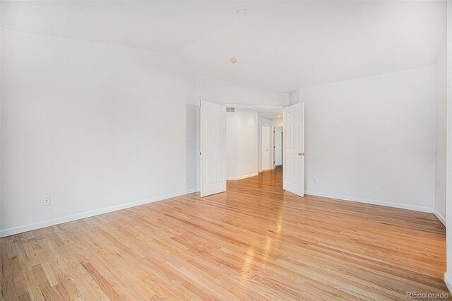 5607 S Gray St, Littleton, CO 80123 - unfurnished room featuring baseboards, vaulted ceiling, and light wood-type flooring