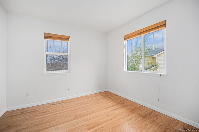 5607 S Gray St, Littleton, CO 80123 - unfurnished room featuring baseboards, wood finished floors, and visible vents