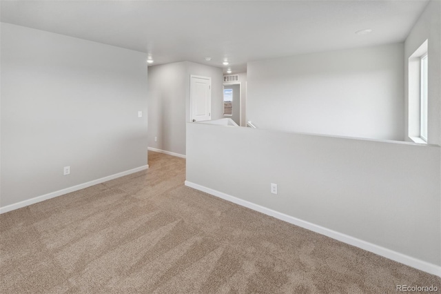 unfurnished room featuring carpet floors and baseboards