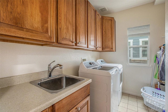 11973 Song Bird Hills St, Parker, CO 80138 - laundry room featuring washer and clothes dryer, light tile patterned floors, and cabinet space