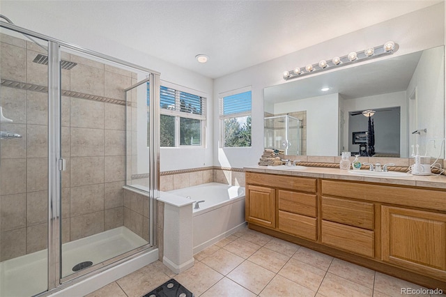 11973 Song Bird Hills St, Parker, CO 80138 - bathroom with tile patterned floors, a garden tub, double vanity, and a shower stall