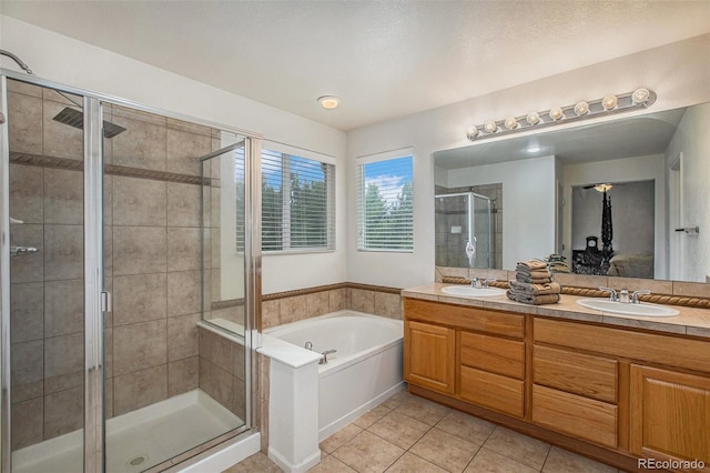 11973 Song Bird Hills St, Parker, CO 80138 - full bathroom with a garden tub, tile patterned flooring, double vanity, and a stall shower