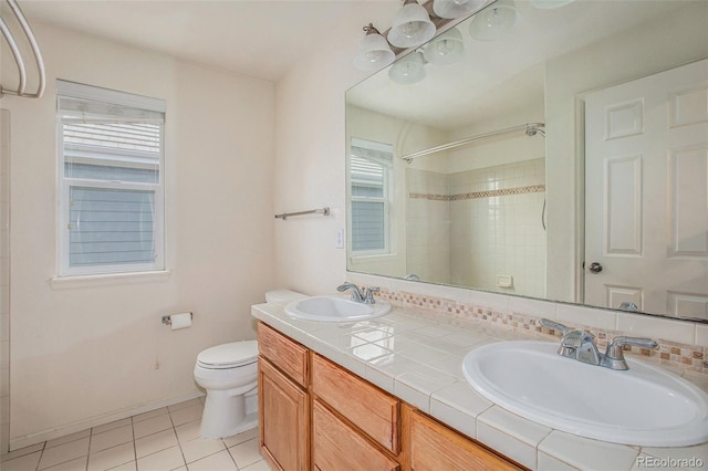 11973 Song Bird Hills St, Parker, CO 80138 - bathroom featuring a shower, tile patterned flooring, double vanity, and tasteful backsplash