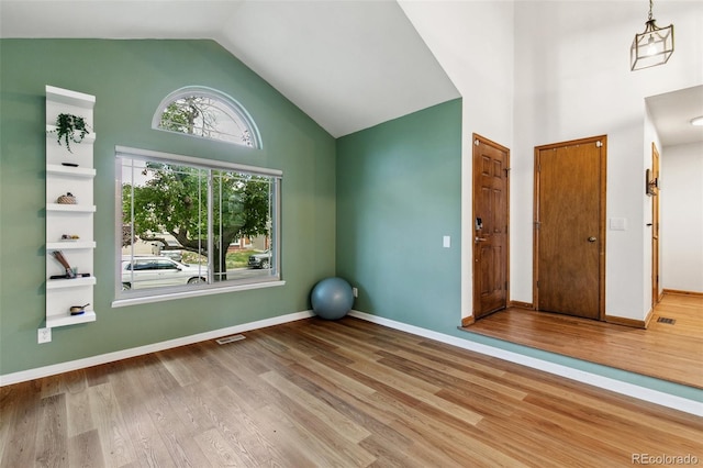 6980 Native Cir, Colorado Springs, CO 80919 - workout room featuring high vaulted ceiling, wood finished floors, and baseboards