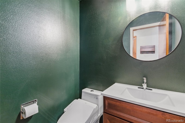 6980 Native Cir, Colorado Springs, CO 80919 - bathroom with vanity, toilet, and a textured wall