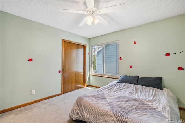 6980 Native Cir, Colorado Springs, CO 80919 - bedroom featuring baseboards, a textured ceiling, light carpet, a closet, and a ceiling fan