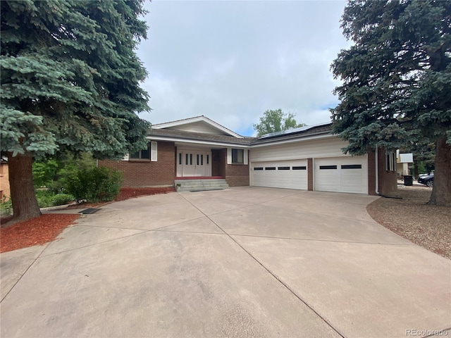 7079 Estes Dr, Arvada, CO 80004 - ranch-style house featuring brick siding, concrete driveway, and an attached garage