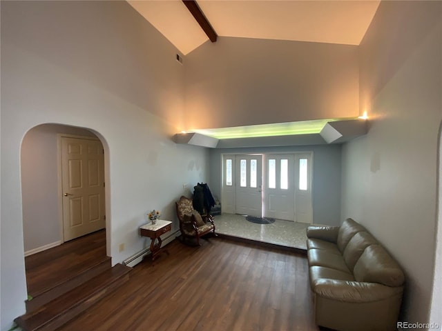 7079 Estes Dr, Arvada, CO 80004 - living room with a baseboard heating unit, wood finished floors, arched walkways, beam ceiling, and high vaulted ceiling