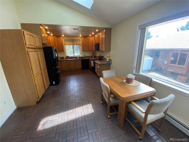 7079 Estes Dr, Arvada, CO 80004 - dining room with a baseboard radiator, a skylight, vaulted ceiling, and baseboards