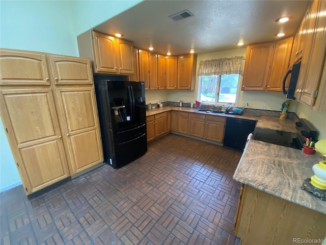 7079 Estes Dr, Arvada, CO 80004 - kitchen with black appliances, recessed lighting, brick patterned flooring, and a sink