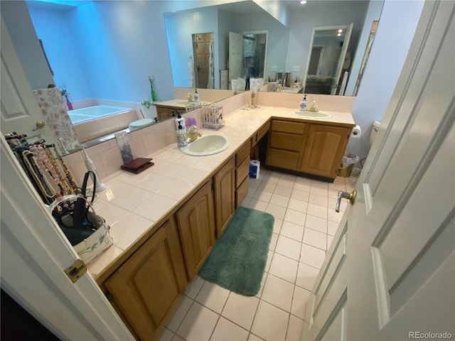7079 Estes Dr, Arvada, CO 80004 - full bath featuring tile patterned floors, a bath, double vanity, and a shower stall