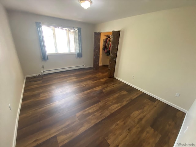 7079 Estes Dr, Arvada, CO 80004 - unfurnished bedroom featuring baseboard heating, dark wood finished floors, a closet, and baseboards