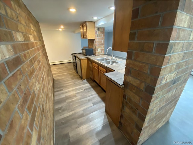 7079 Estes Dr, Arvada, CO 80004 - kitchen featuring a sink, light wood-type flooring, baseboard heating, black microwave, and brown cabinets