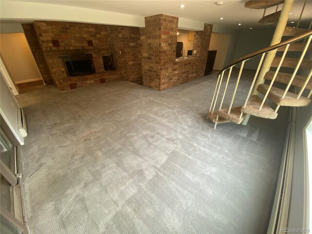7079 Estes Dr, Arvada, CO 80004 - unfurnished living room featuring a fireplace, carpet flooring, stairs, and recessed lighting