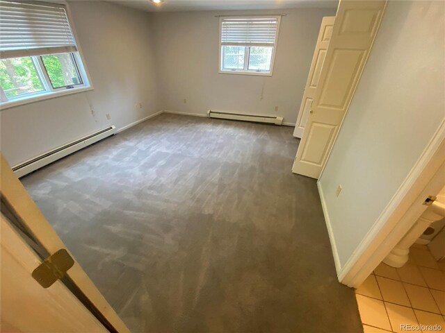 7079 Estes Dr, Arvada, CO 80004 - unfurnished room featuring a baseboard heating unit, carpet floors, and baseboards