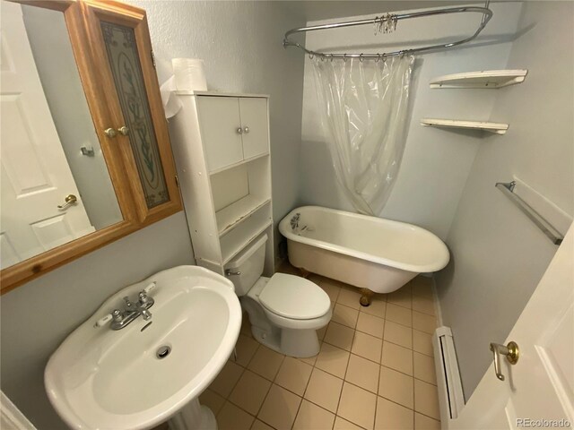 7079 Estes Dr, Arvada, CO 80004 - bathroom featuring a baseboard radiator, tile patterned flooring, a sink, and toilet
