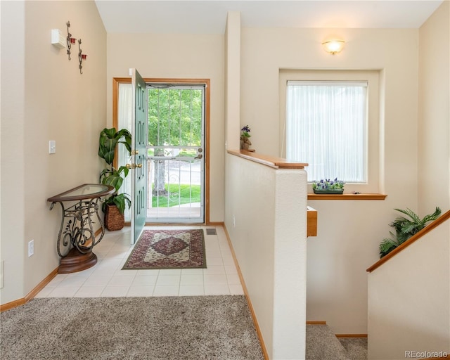 entryway featuring plenty of natural light and light tile patterned floors