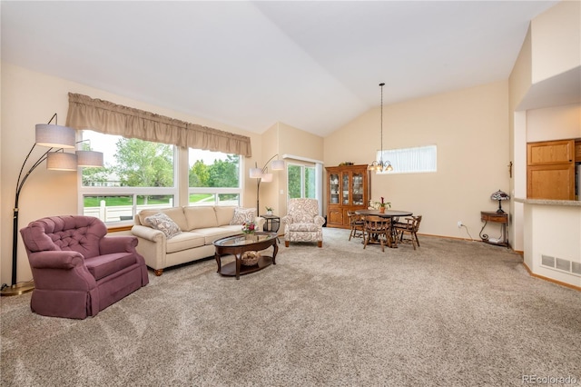 carpeted living room with lofted ceiling and a chandelier