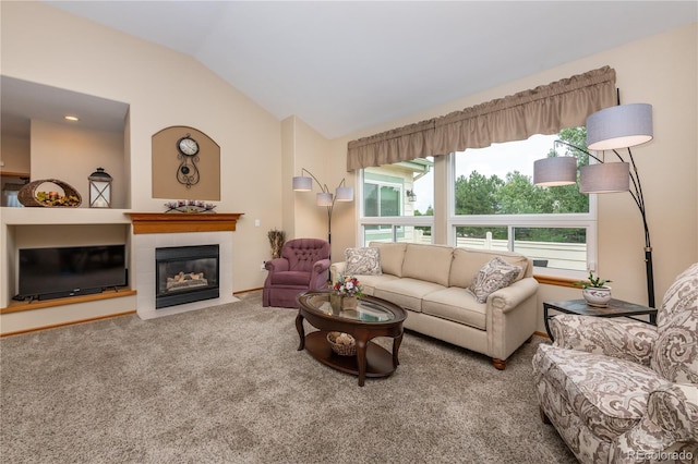 living room featuring carpet, a tiled fireplace, and vaulted ceiling