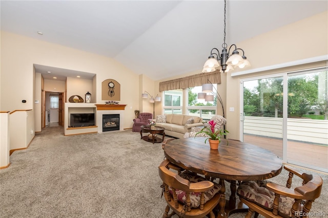 dining area featuring lofted ceiling, carpet, and a notable chandelier