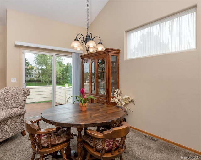 dining area with high vaulted ceiling, an inviting chandelier, and carpet flooring