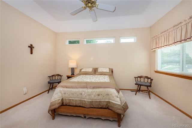 bedroom with ceiling fan, multiple windows, and carpet floors