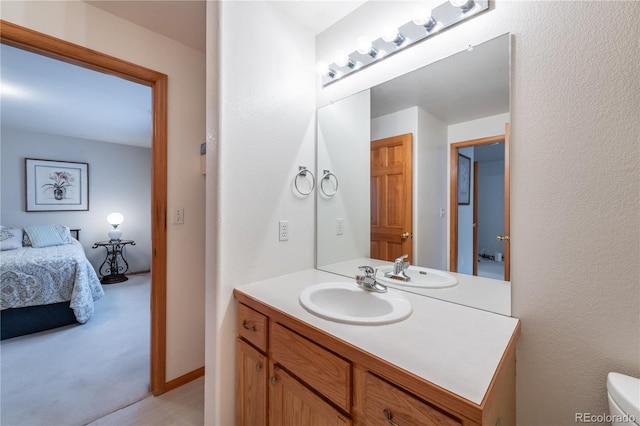 bathroom with toilet and vanity