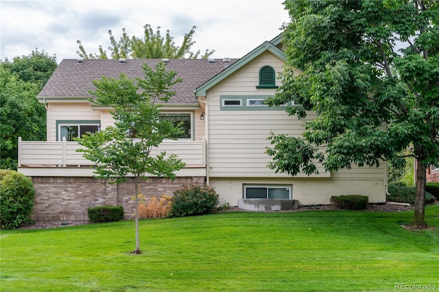 rear view of house featuring a lawn