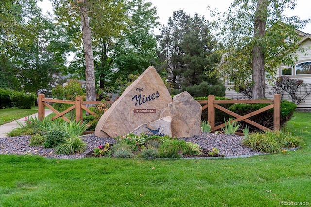 community / neighborhood sign with a lawn