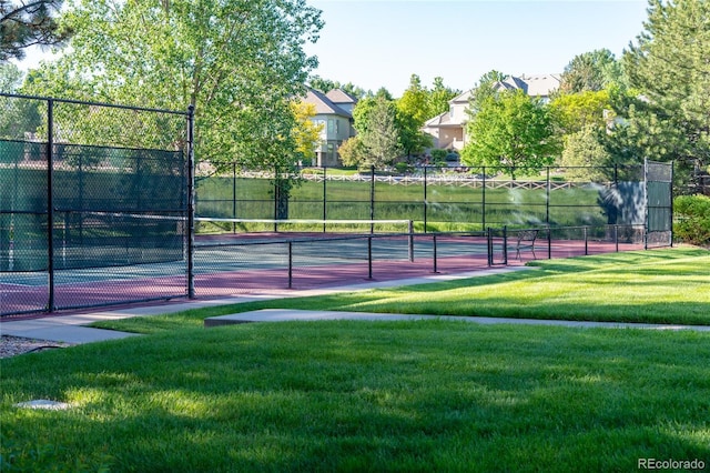 view of sport court with a yard