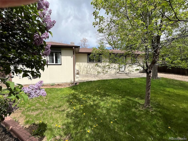 exterior space featuring a lawn and a patio