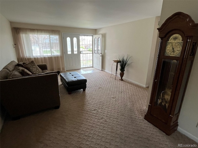 carpeted living room featuring baseboards