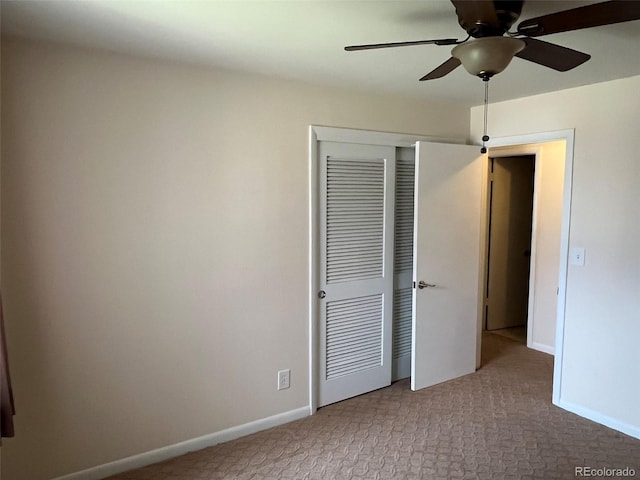 unfurnished bedroom with carpet floors, a ceiling fan, baseboards, and a closet