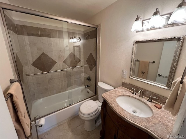 full bath featuring vanity, combined bath / shower with glass door, and toilet
