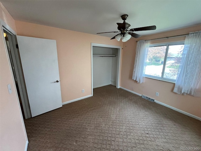 unfurnished bedroom with a closet, carpet flooring, baseboards, and visible vents