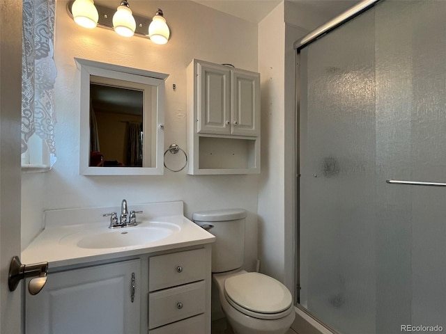 full bath with vanity, toilet, and a shower stall