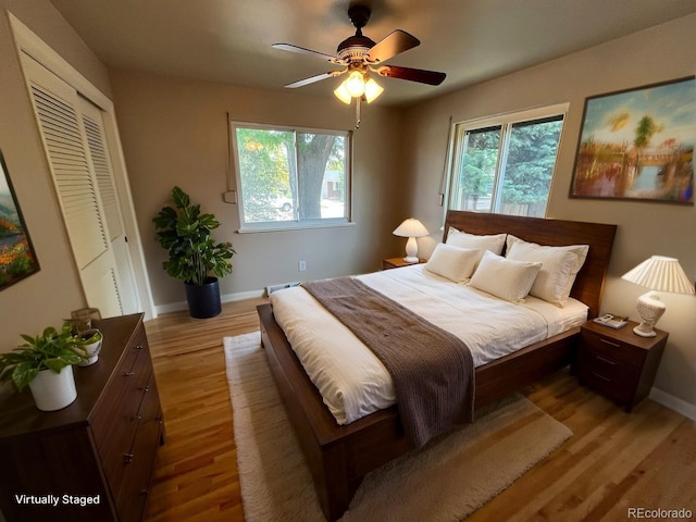 6085 Simms St, Arvada, CO 80004 - bedroom with light wood-type flooring, multiple windows, a closet, and ceiling fan