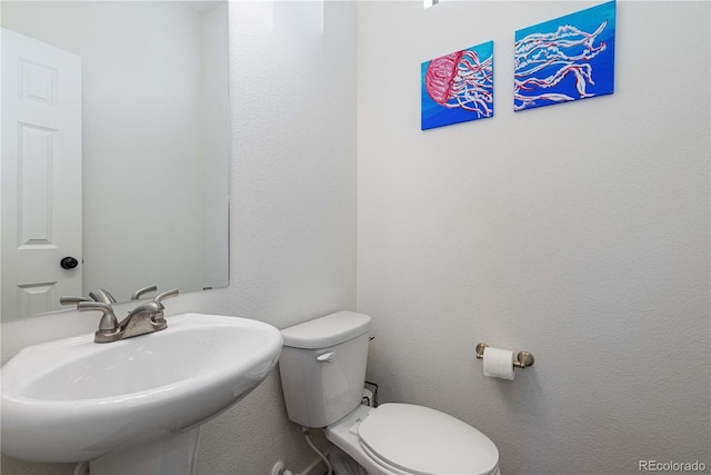 half bathroom with a sink and toilet