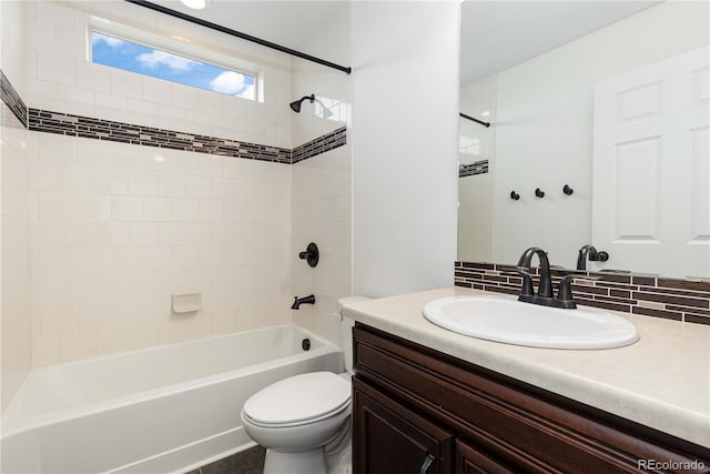 bathroom featuring vanity, shower / tub combination, and toilet