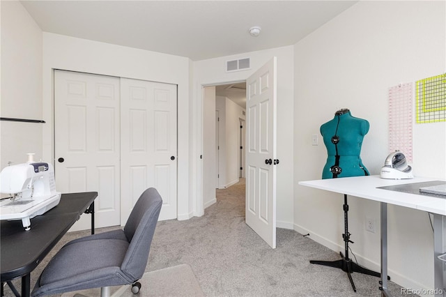 office featuring light colored carpet, baseboards, and visible vents