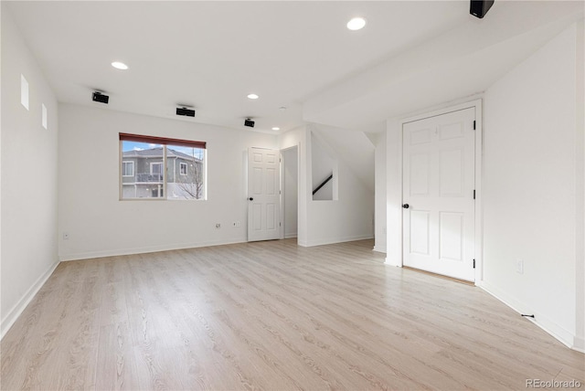 unfurnished living room featuring recessed lighting, baseboards, and light wood finished floors