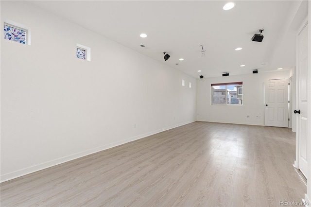 empty room featuring baseboards, recessed lighting, and light wood-style flooring