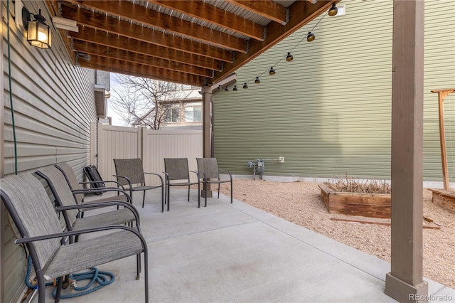 view of patio / terrace with a garden and fence