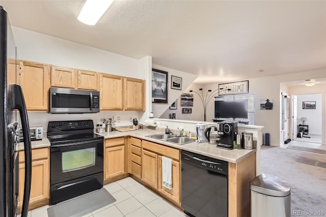 kitchen featuring kitchen peninsula, sink, light brown cabinets, and black appliances