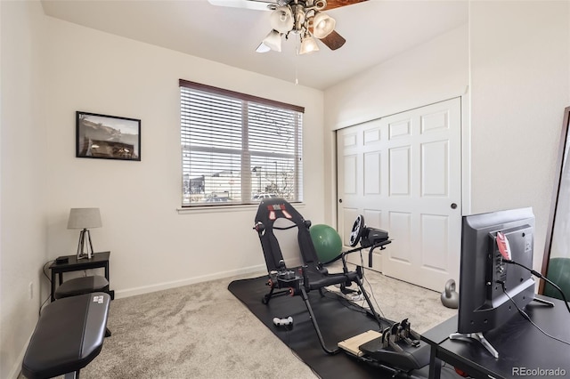 exercise area featuring light carpet and ceiling fan