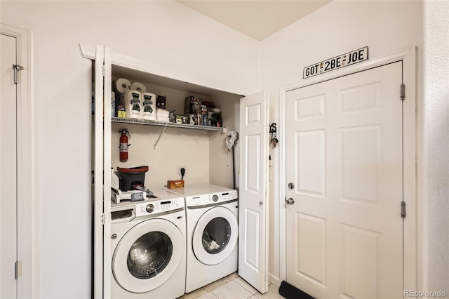 laundry room featuring light tile patterned floors and washer and clothes dryer