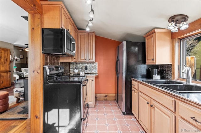 kitchen with appliances with stainless steel finishes, light brown cabinetry, sink, backsplash, and light tile patterned floors