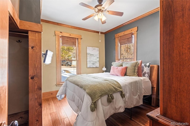 bedroom featuring hardwood / wood-style flooring, ceiling fan, and ornamental molding